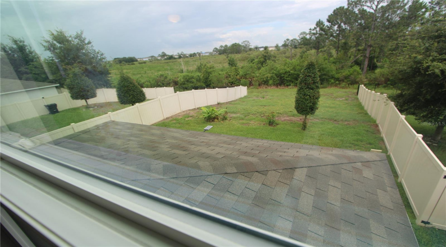 Peaceful views from the primary suite overlooking the backyard