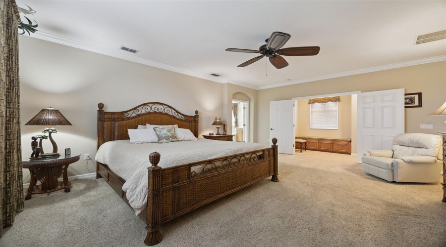 Large primary bedroom with double door entry