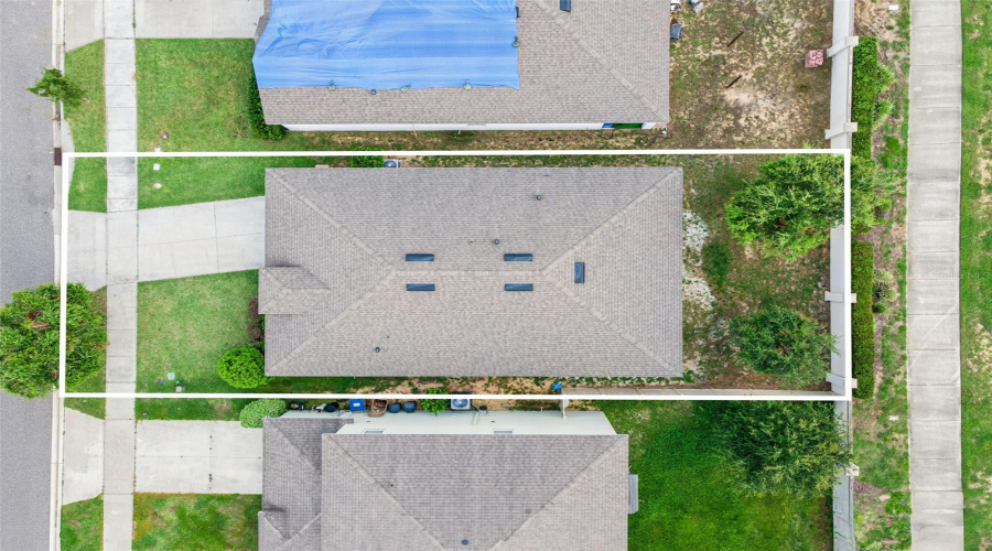 Outlined Property Boundaries:Top-down aerial perspective with outlined lot boundaries detailing the complete property dimensions and footprint.