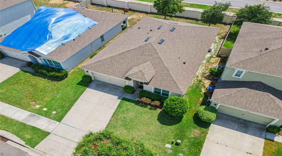 Front Aerial Elevation:Elevated front aerial view showcasing the attractive single-story façade, spacious double-wide concrete driveway, and attached two-car garage.