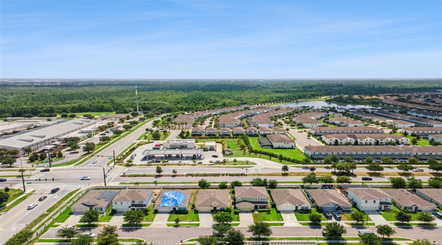 High-Altitude Neighborhood Overview:Panoramic community aerial view highlighting the prime location near local conveniences, major thoroughfares, and surrounding natural green spaces.