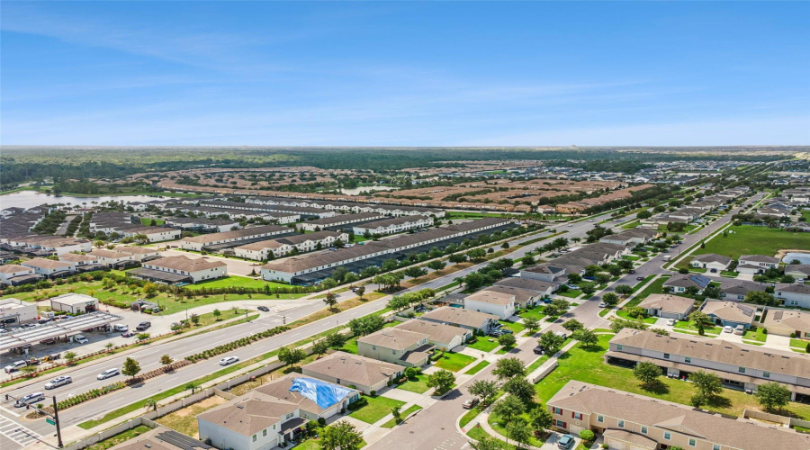 Convenient Location & Amenities:Wide aerial perspective highlighting the home’s prime location with immediate access to major thoroughfares, nearby retail plazas, and local dining options.