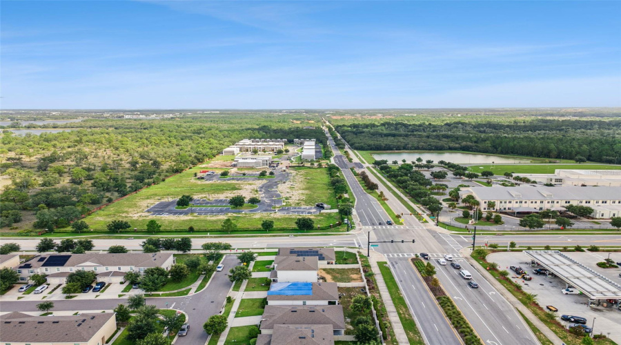 Regional Aerial Overview:Expansive high-angle view illustrating seamless connectivity to main intersections, nearby schools, local services, and surrounding natural conservation areas.