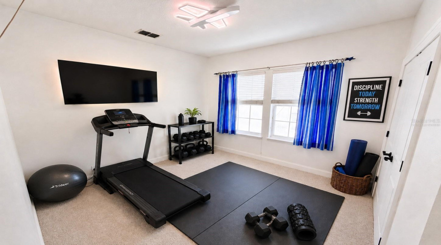 Fourth bedroom upstairs (virtually staged as gym - has closet)