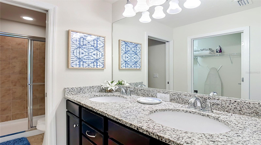 Primary bathroom with dual vanities & walk-in shower