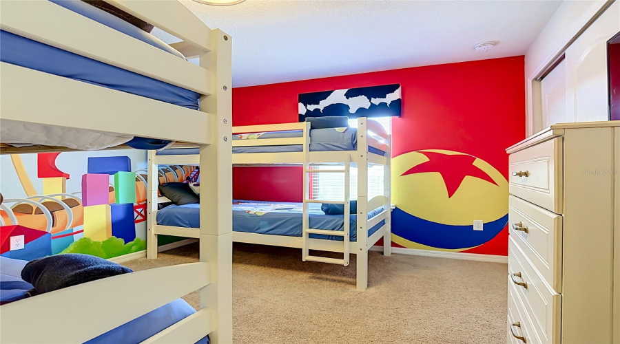 Custom-themed bunk room featuring a hand-painted mural by a local artist
