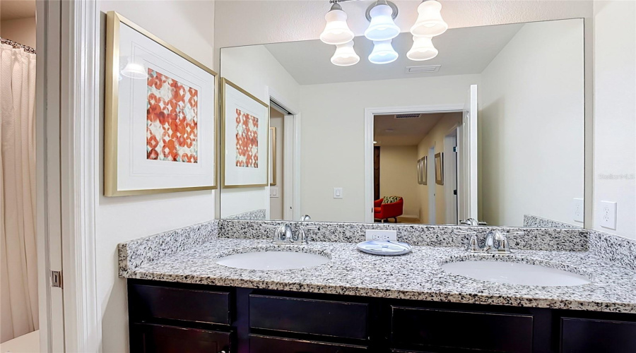Guest bathroom with granite vanity & shower/tub combination