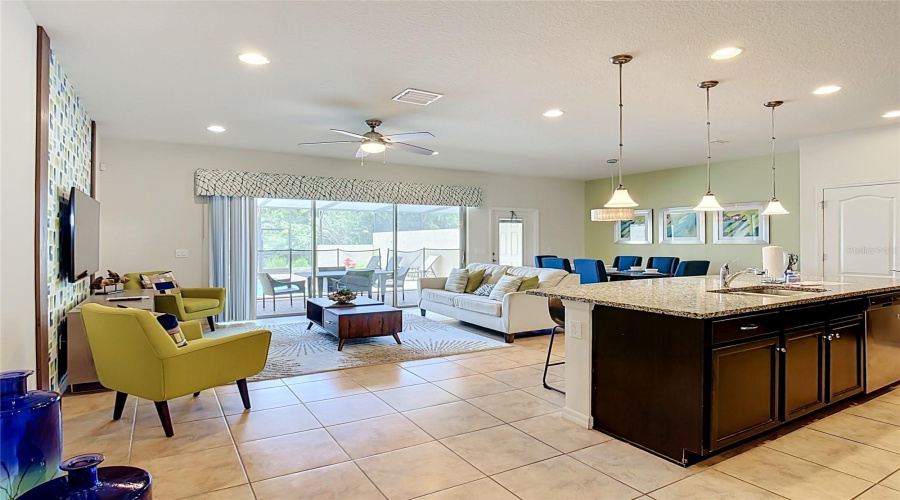 Bright open-concept living area with pond views