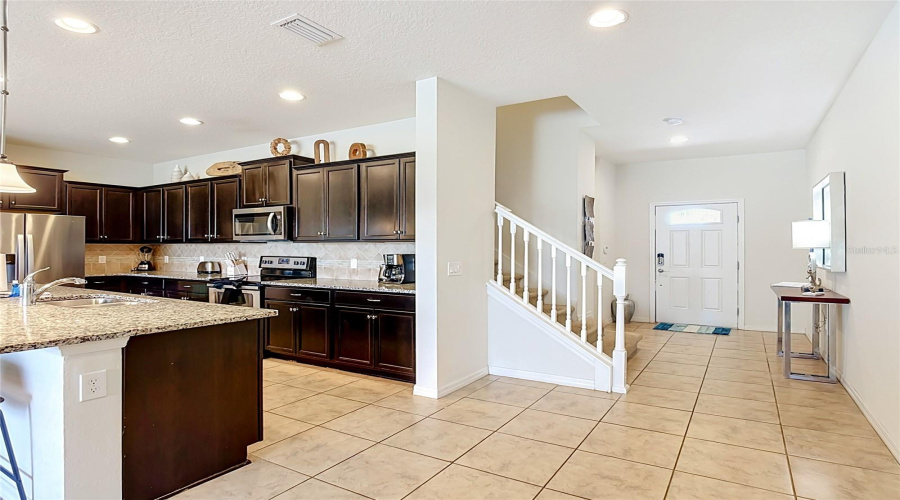 Spacious kitchen with upgraded white quartz countertops
