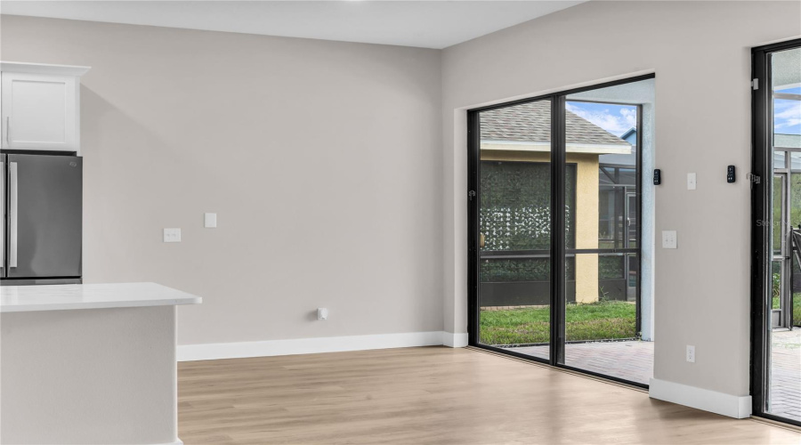 Breakfast Nook opens to Family Room with large slider doors that lead to covered lanai and screen enclosed pool.
