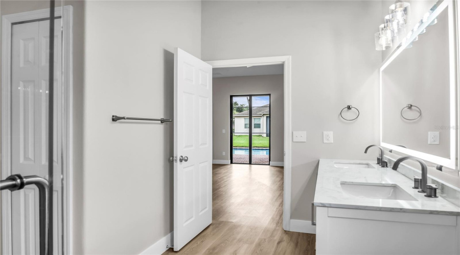 Fully redesigned First Floor Primary Bath features a double quartz vanity with anti-fog LED light up mirror and glass enclosed walk in tile shower.