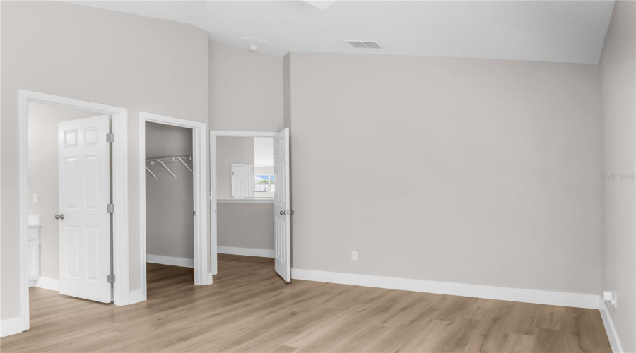 Second Primary Bedroom located on second floor features LVP flooring, walk-in closet and ensuite bath