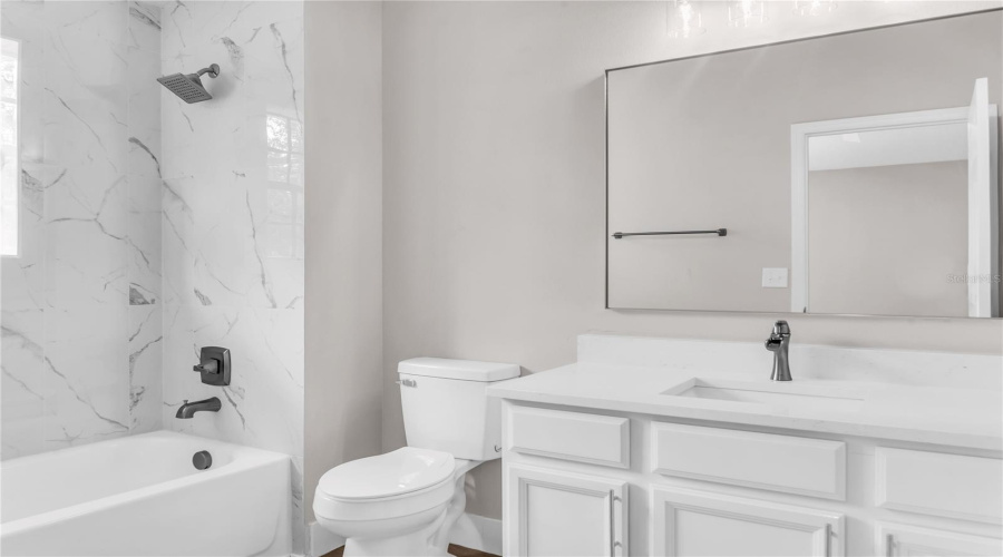 Second Primary Bedroom Bath with quartz vanity and tiled shower/tub combo