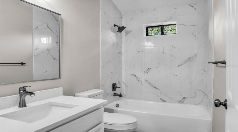 Bedroom 3 ensuite bath with quartz vanity and tiled shower/tub combo