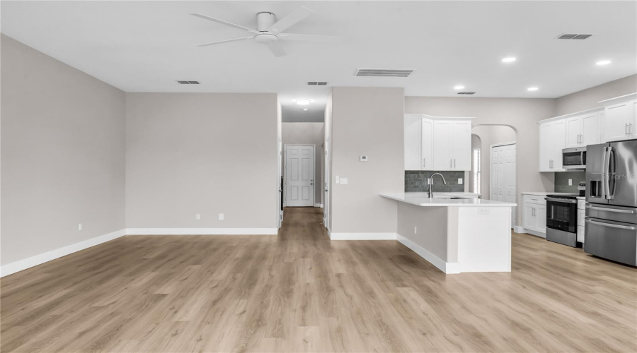 Fully remodeled Kitchen with brand new 42" soft close cabinets, quartz countertops, modern glass tile backsplash, brand new stainless steel appliances, breakfast nook and opens to spacious Family Room and Breakfast Nook