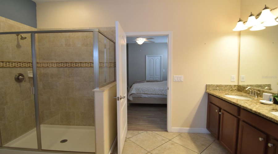En suite with tub, separate shower, door to pool deck