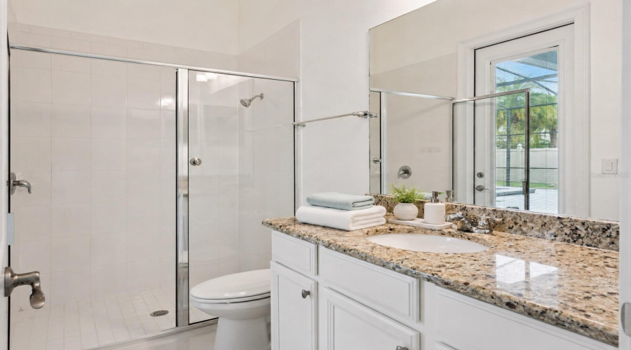 Convenient pool bath with direct access to the outdoor pool area.