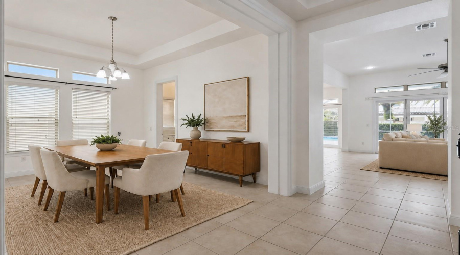 As you enter through the front hallway, you’re welcomed by separate formal living and dining rooms that flow seamlessly into the open-concept kitchen and main living area.