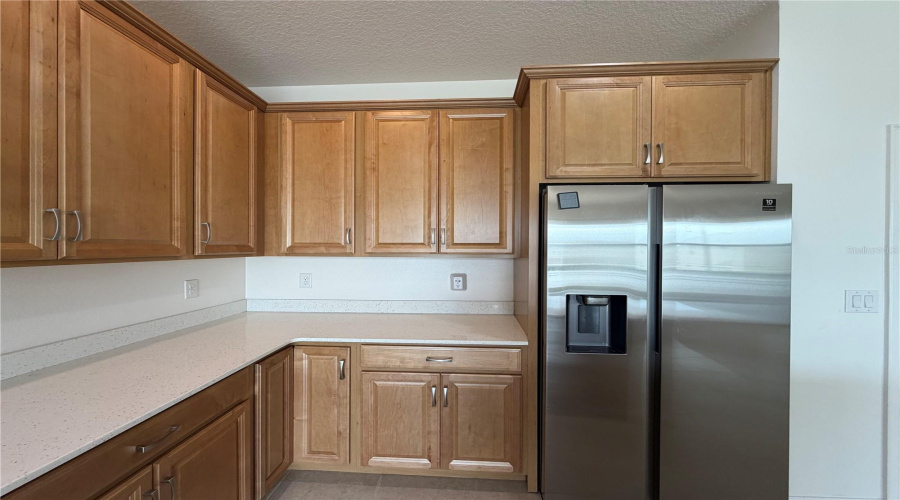 Kitchen with side by side refrigerator