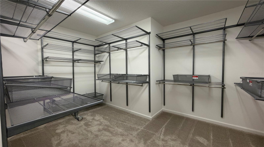 Primary bedroom walk in closet