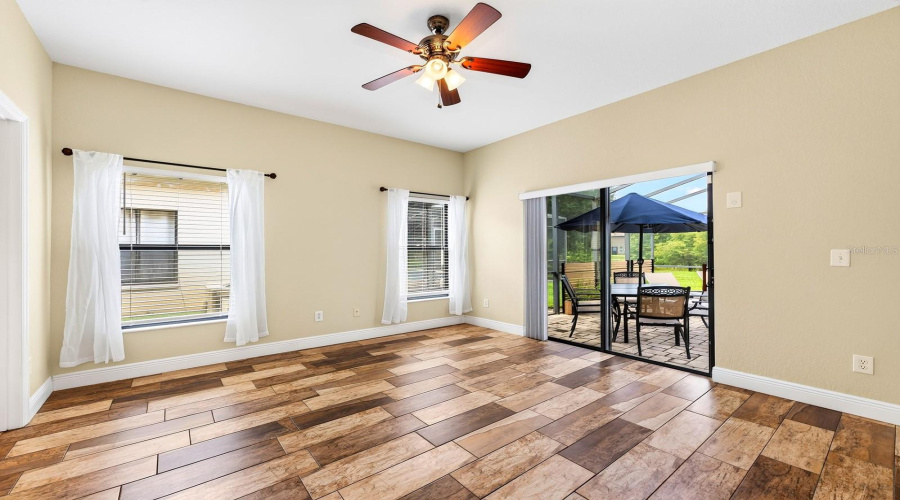 Bedroom 2 has sliding doors leading to the patio/pool area.