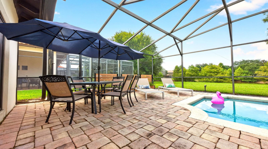 A PAVER PATIO provides plenty of room for lounging, dining and entertaining after a day at the parks—or simply relaxing poolside while taking in the tranquil view.