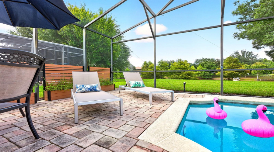 A PAVER PATIO provides plenty of room for lounging, dining and entertaining after a day at the parks—or simply relaxing poolside while taking in the tranquil view.