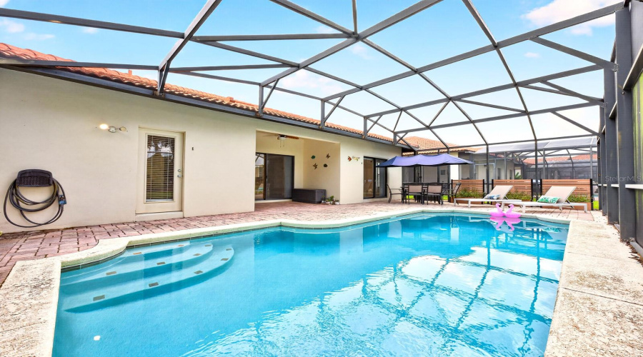 The SCREENED LANAI surrounds the HEATED IN-GROUND POOL with NEW POOL HEATER (2025) and NEW FILTER (2026).