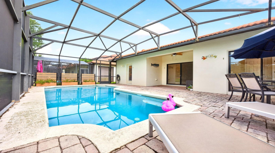 The SCREENED LANAI surrounds the HEATED IN-GROUND POOL with NEW POOL HEATER (2025) and NEW FILTER (2026).