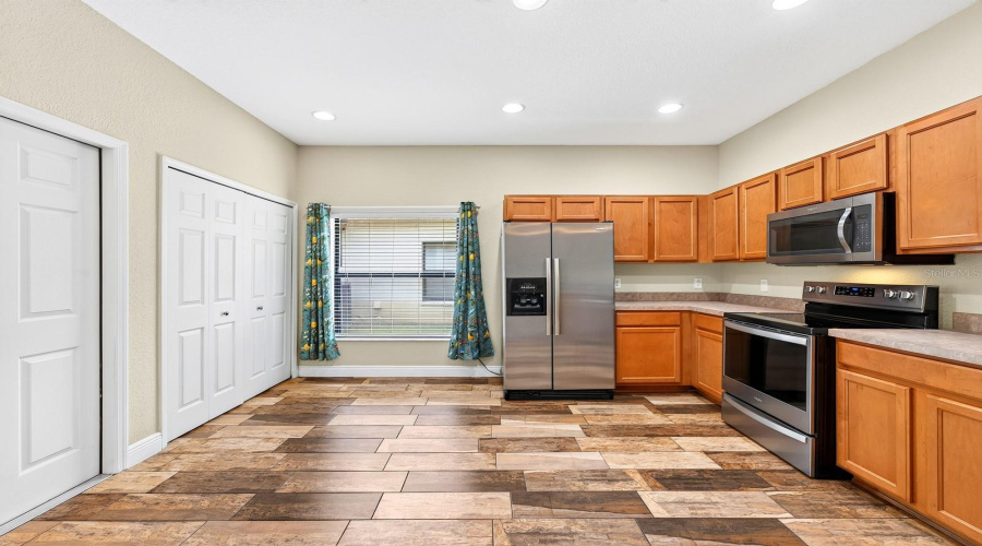 The Kitchen features stainless steel appliances, including a NEW WHIRLPOOL STOVE AND DISHWASHER (2023), along with a closet pantry, breakfast bar and sunny BREAKFAST NOOK.