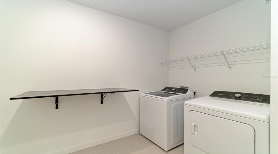 Expansive Laundry Room With Folding Station