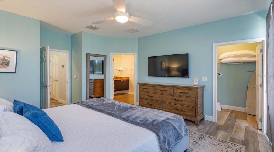Large Primary Bedroom With Elegant Furnishings, Natural Light, And Serene Vacation-Style Ambiance.