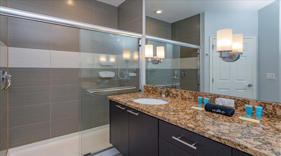Oversized Walk-In Shower With Modern Tile Design And Upgraded Bathroom Fixtures.