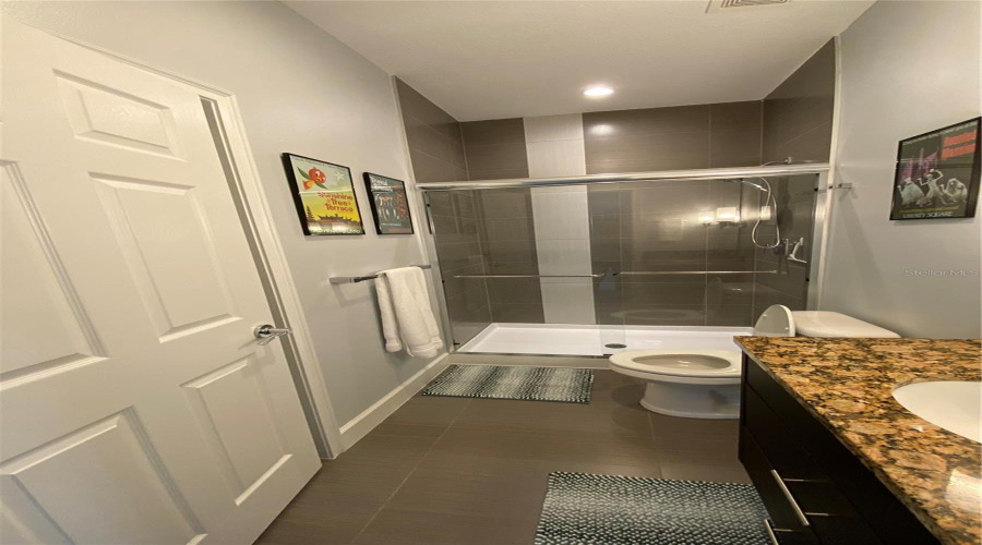 Stylish Guest Bathroom Featuring A Granite Countertop And Modern Finishes.