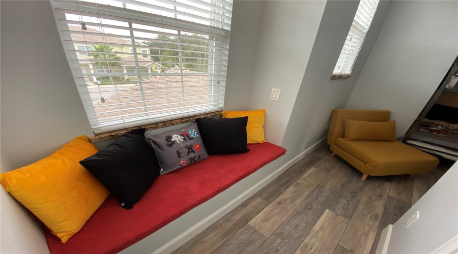 Cozy Corner Bench With Decorative Pillows, Creating A Charming Reading Nook In The Children’s Bedroom.