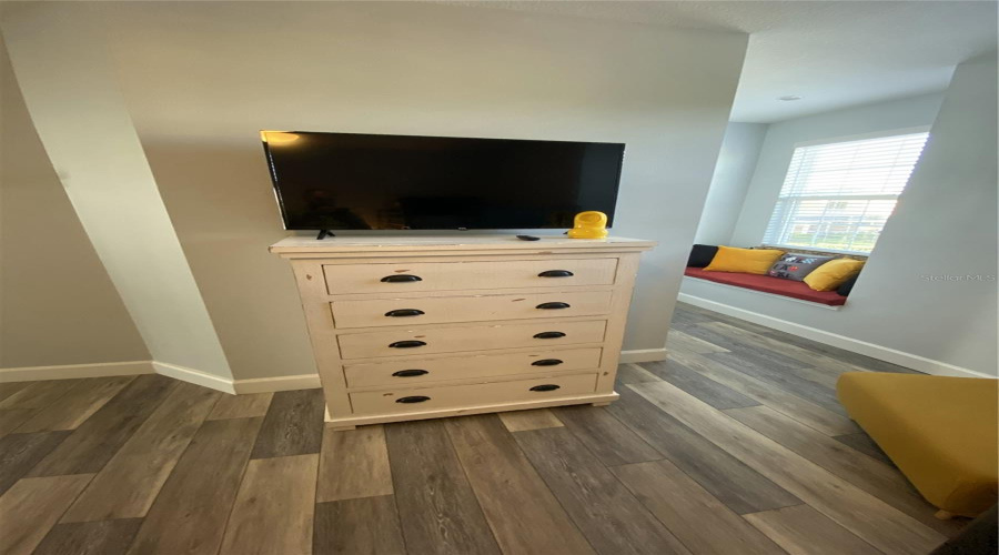 Additional View Of The Children’s Bedroom Featuring A Tv And Media Console.