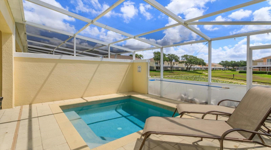 Private Splash Pool With Tranquil Pond Views And Screened Enclosure For Added Comfort And Privacy.