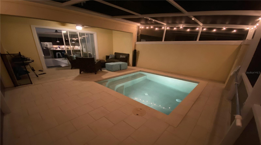 Evening View Of The Private Screened-In Patio And Illuminated Pool, Perfect For Relaxing Or Entertaining After Sunset.