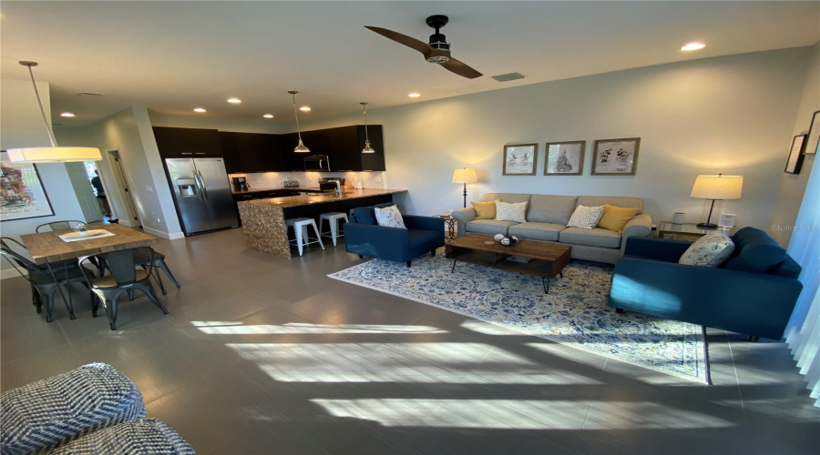 Spacious Open-Concept Living, Dining, And Kitchen Area Featuring Modern Finishes, Tile Flooring, And Plenty Of Room For Gathering.