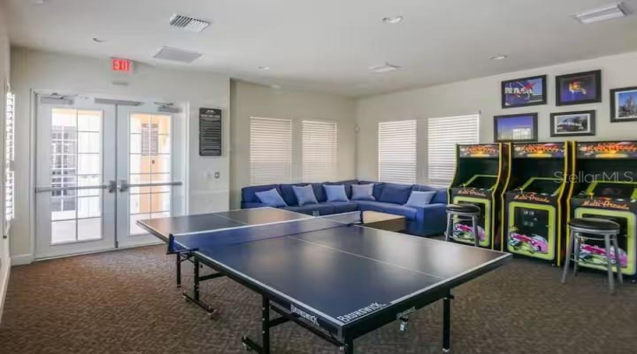 Community Clubhouse Offering A Game Room With Arcade Machines And Table Tennis For Added Entertainment.