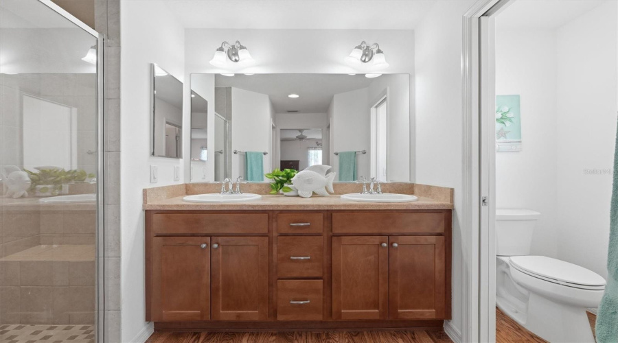Double Sinks, Tile Shower And Water Closet