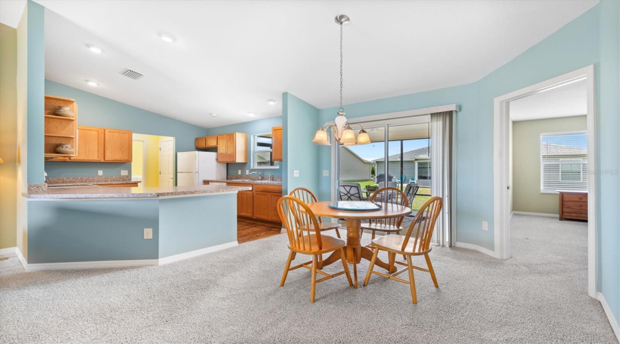 Open Floor Plan With Kitchen Penisula Island Overlooking The Dining And Living Space.
