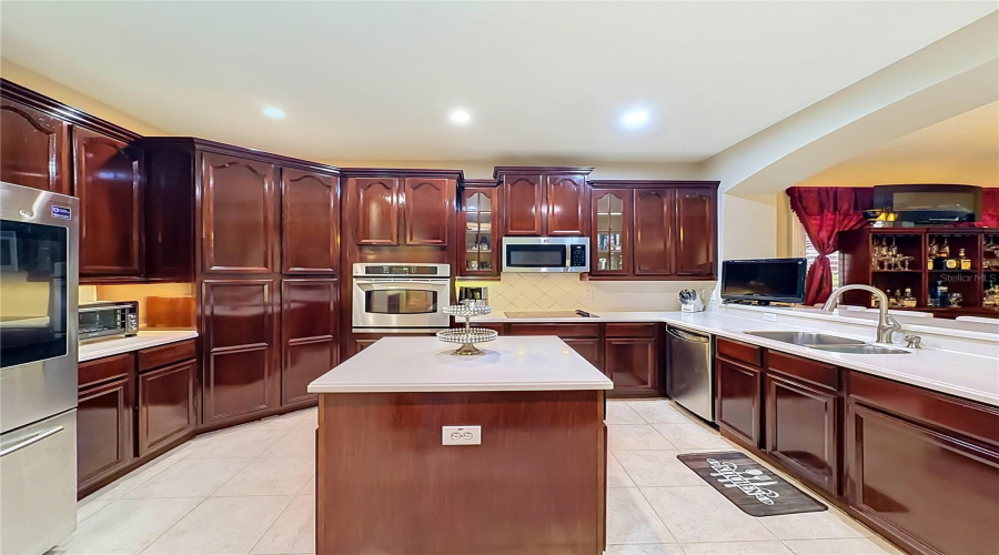 High End Kitchen, Beautiful Wood Cabinets, Corian Counters, Refrigerator W/Display, Double Stainless Steel Sink, And More!