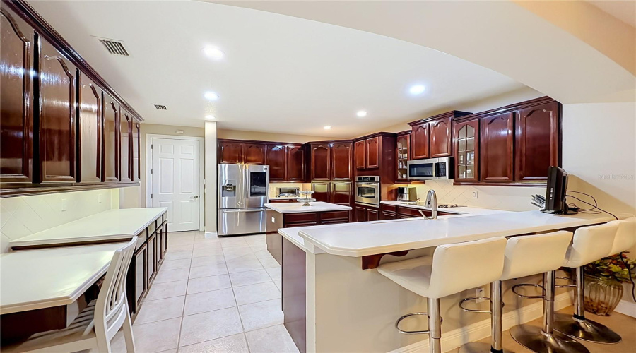 Built In Desk, Loads Of Prep Area, Cabinets And Bar Seating.