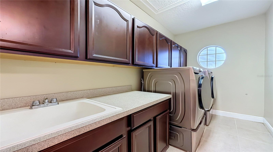 Upstairs Laundry Room, Cabinets And Utility Sink.