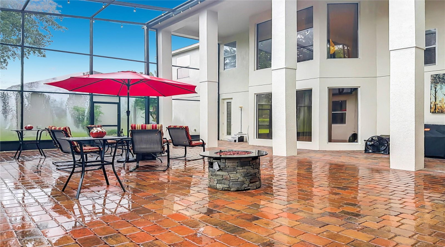 Outdoor Living Area. 2-Story Screen Enclosure With Paver Flooring. Door Access To Downstairs Bath