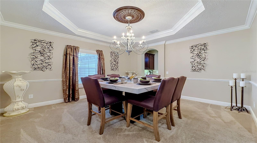 Formal Dining Area, Butler Pantry Access To Kitchen, Tray Ceiling, Crown Molding And Chair Rail Features.