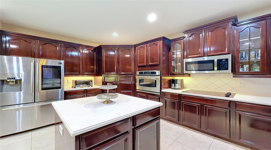 High End Kitchen, Refrigerator W/Display, Wall Oven, Microwave Hood, Cooktop, Center Island With Loads Of Cabinets And Prep Space.