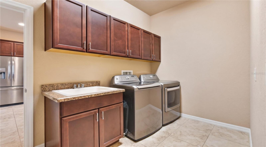 Laundry Room With Utility Sink And Cabinets