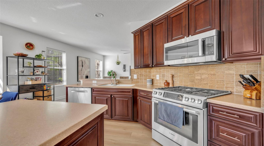 Beautiful Kitchen Cabinetry With Stainless Steel Appliances Including A Gas Range